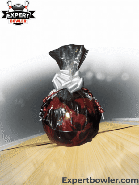 Gift wrapped bowling ball with a festive bow, displayed on a bowling lane, featuring the ExpertBowler logo, symbolizing a perfect personalized gift.