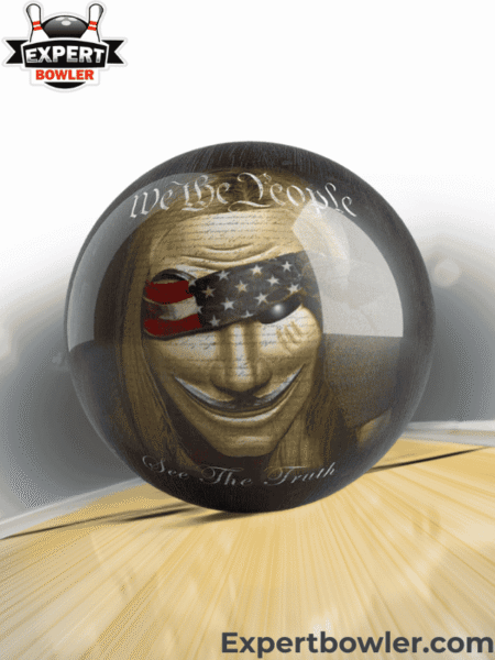 Personalized bowling ball with a patriotic 'We The People' themed design from BowlersParadise.com, set on a bowling lane with ExpertBowler