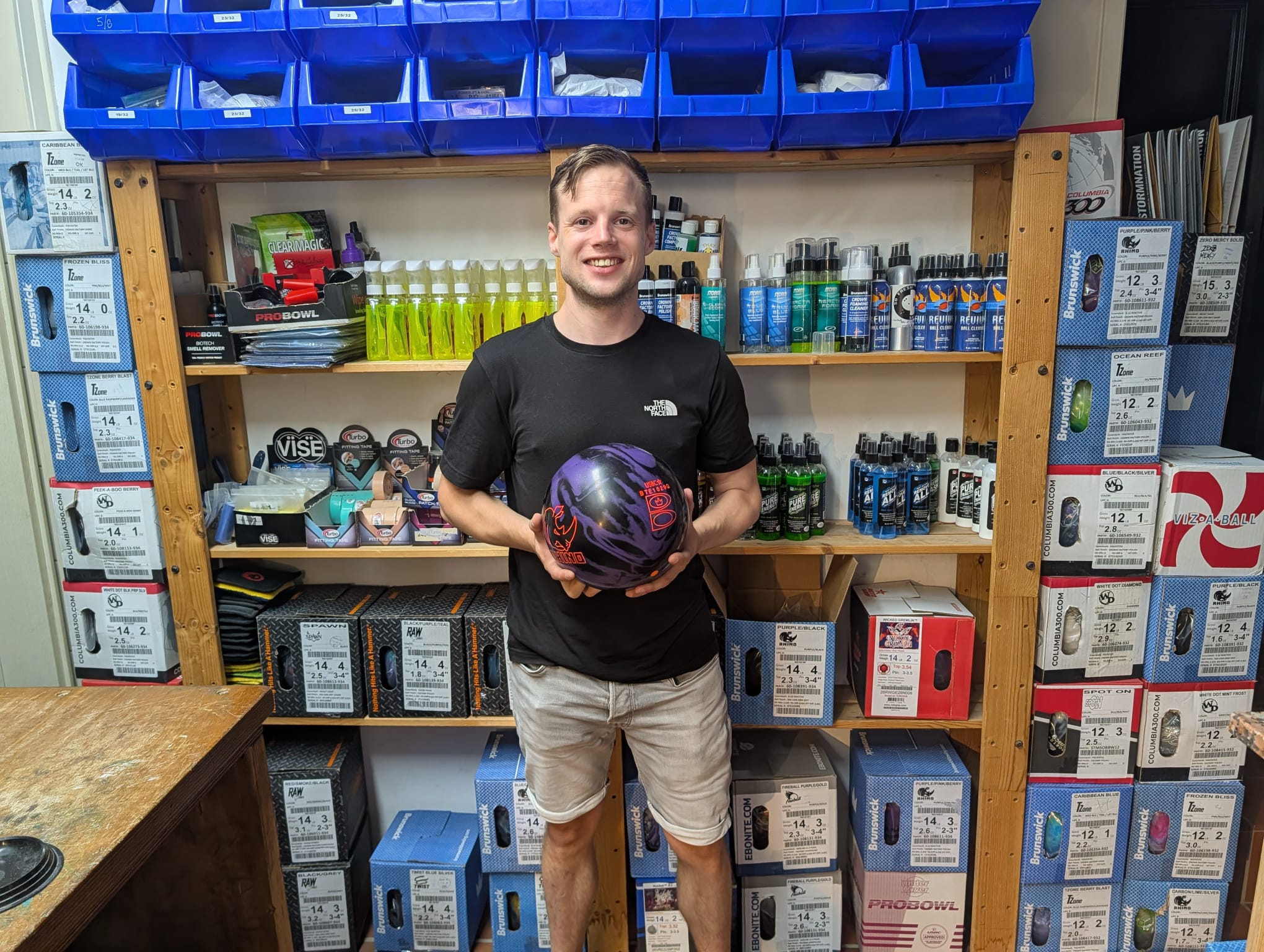 Remco holding the purple and black Brunswick Rhino bowling ball he was fitted for at the pro shop