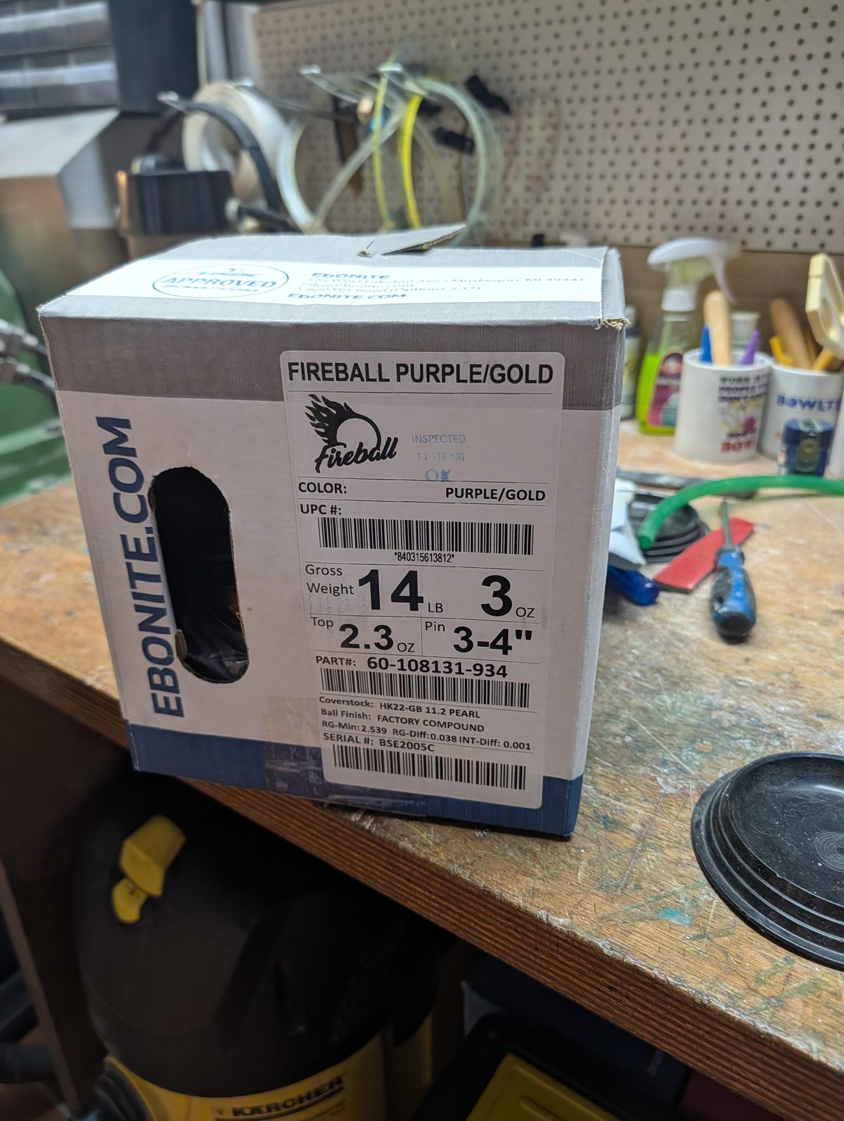 Ebonite Fireball Purple/Gold bowling ball box label showing gross weight 14 lb 3 oz, top weight 2.3 oz, pin 3-4 inches, HK22-GB 11.2 Pearl coverstock, factory compound finish, RG-Min 2.539 and RG-Diff 0.038